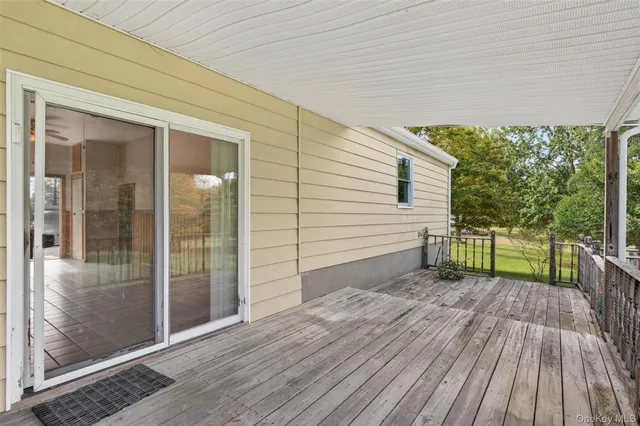 a backyard of a house with lots of green space and outdoor seating