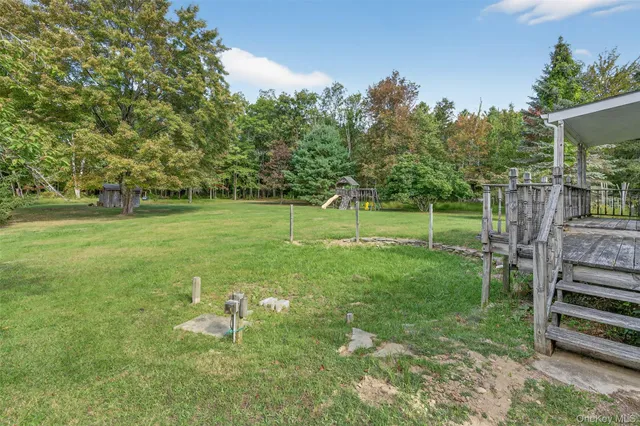 a backyard of a house with barbeque oven table and chairs