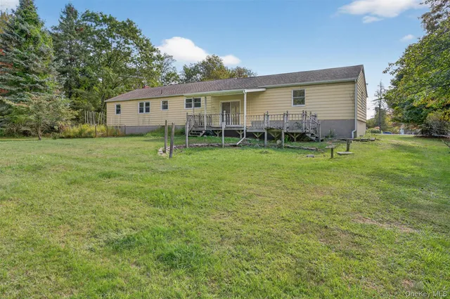 a view of a house with a big yard and a large tree