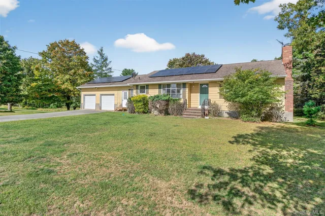 a front view of house with yard and green space