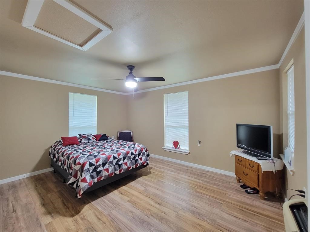 157 Oates Brothers Road Trinity, TX 75862 - Photo 8 of 10 a bedroom with a bed and a flat screen tv