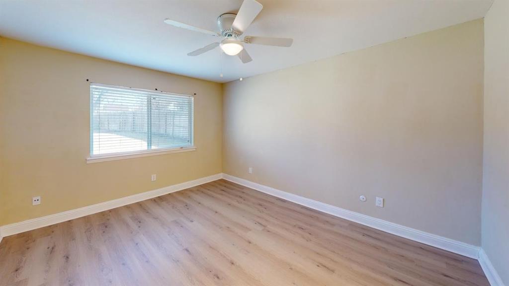 3005 Meandering Way Bedford, TX 76021 - Photo 10 of 22 wooden floor in an empty room with a window