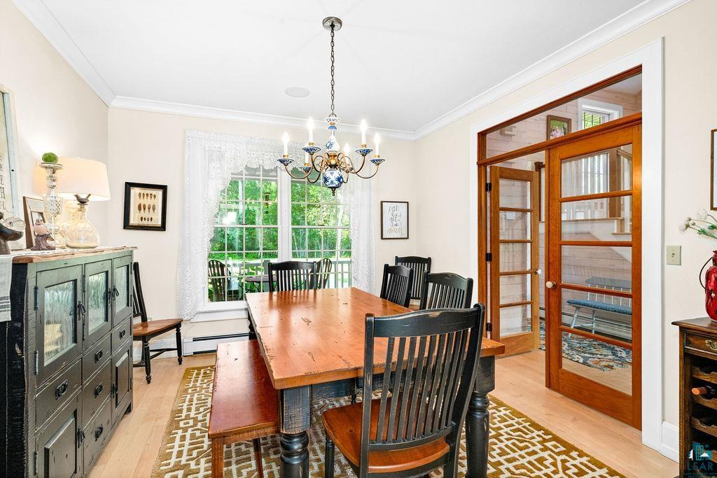 3168 Pioneer Road Barnum, MN 55707 - Photo 13 of 46 This formal dining room is a quiet setting for a hot meal after a long day or, could also be transitioned to an office. Adorned with a classic farmhouse chandelier with tons of character.