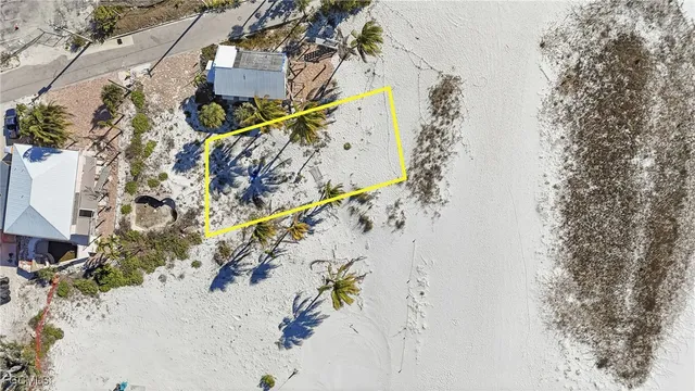 an aerial view of a house with a yard and large trees
