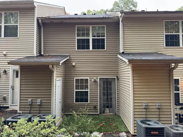 a view of a house with a window and brick walls