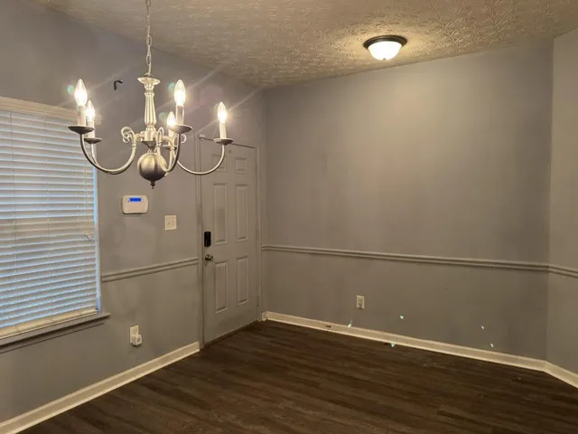 a view of a room with wooden floor and fan
