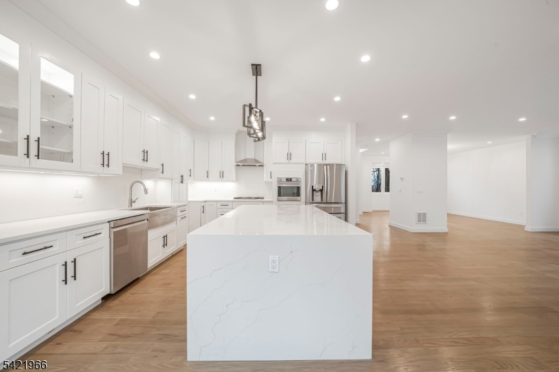 85 Pine Brook Road Montville, NJ 07082 - Photo 15 of 50 a large kitchen with stainless steel appliances kitchen island a large counter top a sink a stove and a refrigerator
