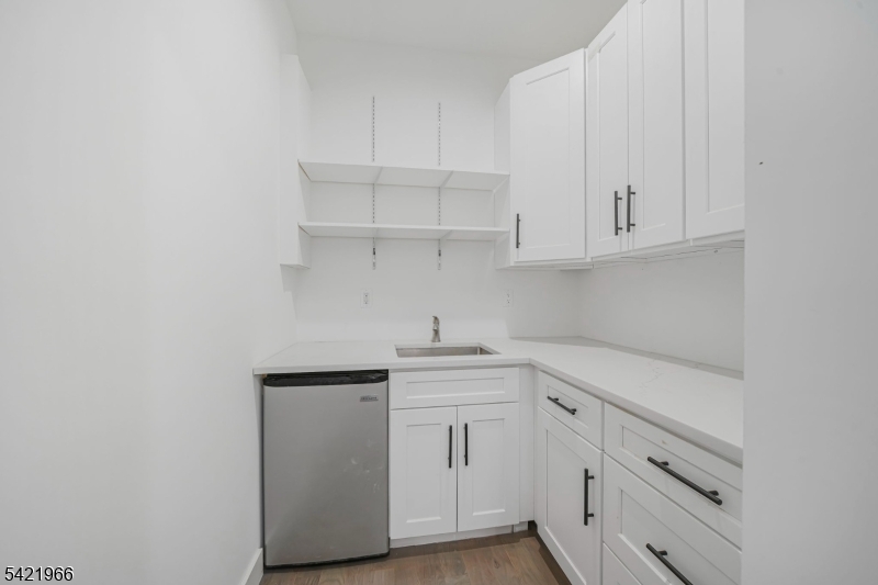 85 Pine Brook Road Montville, NJ 07082 - Photo 19 of 50 a kitchen with white cabinets and a sink