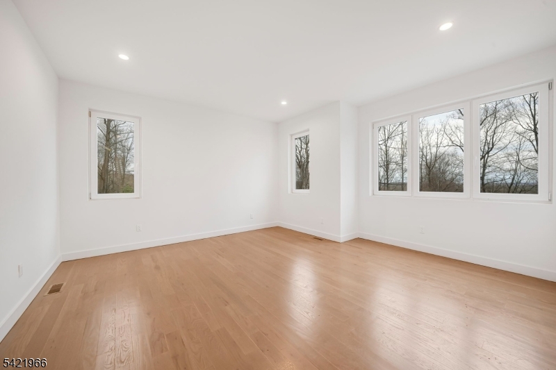 85 Pine Brook Road Montville, NJ 07082 - Photo 25 of 50 a view of an empty room with a window and wooden floor