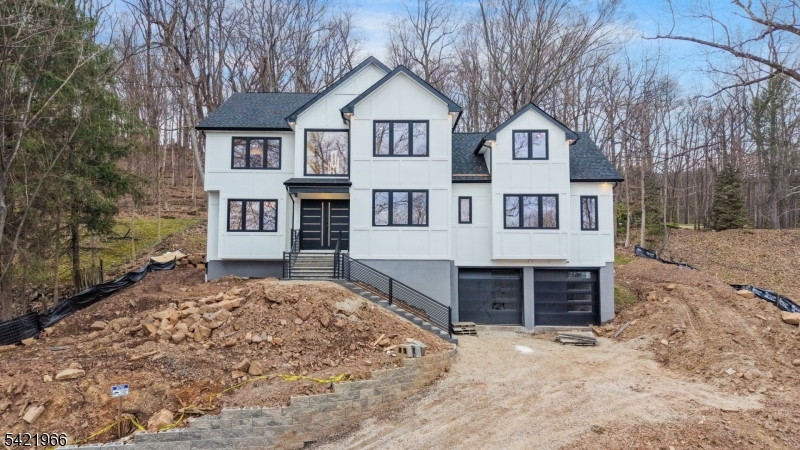 85 Pine Brook Road Montville, NJ 07082 - Photo 3 of 50 a front view of a house with a yard covered with snow