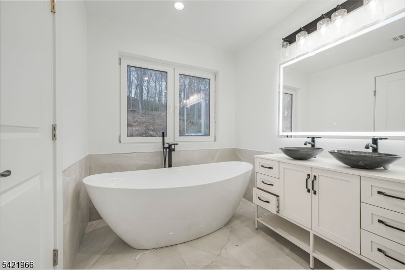 85 Pine Brook Road Montville, NJ 07082 - Photo 33 of 50 a spacious bathroom with a double vanity sink mirror and bathtub