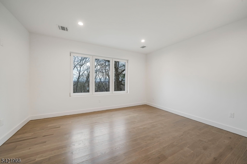 85 Pine Brook Road Montville, NJ 07082 - Photo 34 of 50 an empty room with wooden floor and windows