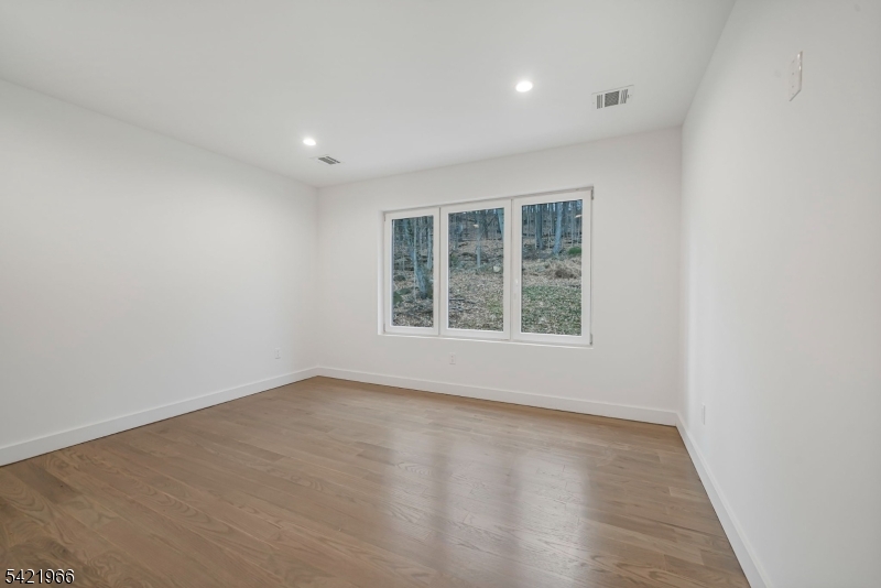 85 Pine Brook Road Montville, NJ 07082 - Photo 35 of 50 an empty room with wooden floor and windows