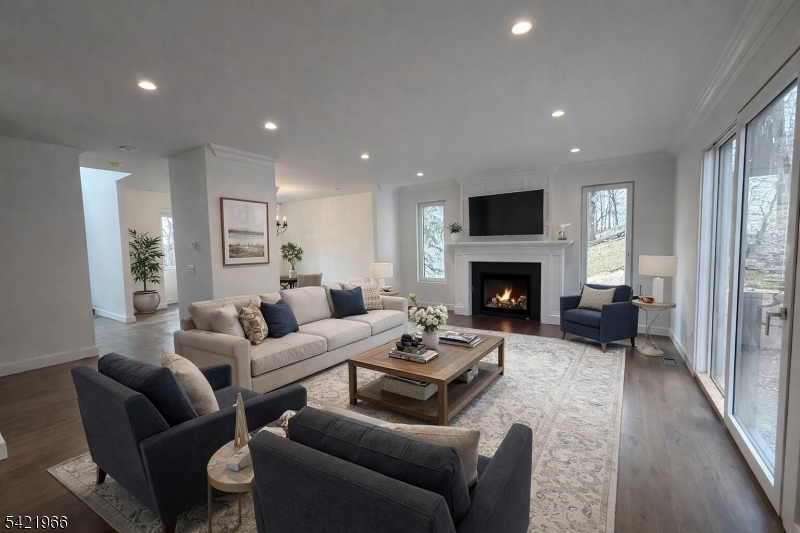 85 Pine Brook Road Montville, NJ 07082 - Photo 9 of 50 a living room with furniture a flat screen tv and a fireplace
