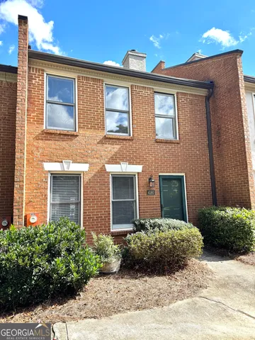 a view of a brick house with a yard