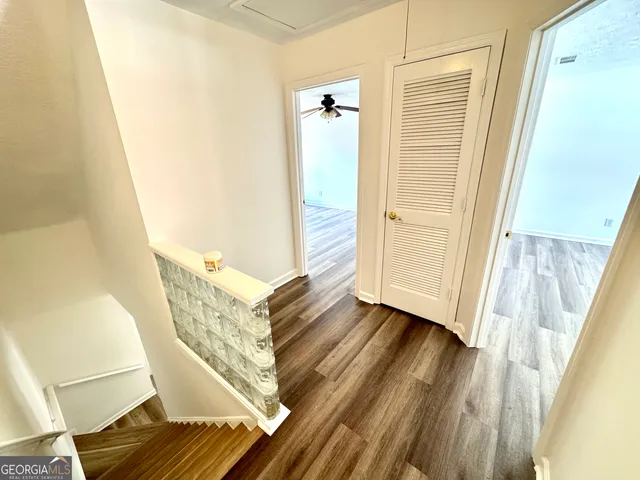 a view of a hallway view with wooden floor and staircase