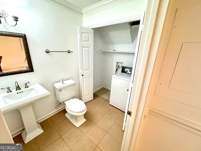 a bathroom with a toilet sink and a mirror