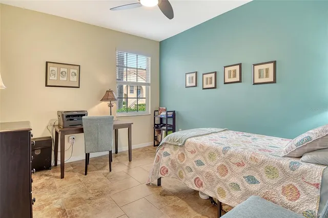 a view of a white house sitting in a big yard with large trees