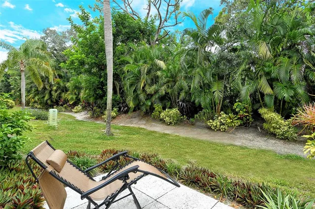 a living room with stainless steel appliances kitchen island granite countertop furniture and a window