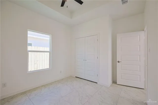 an empty room with windows and closet
