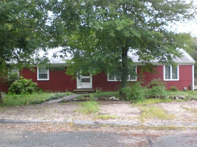 68 Westminster Road Centerville, MA 02632 - Photo 1 of 10 a view of a brick house next to a yard with large trees