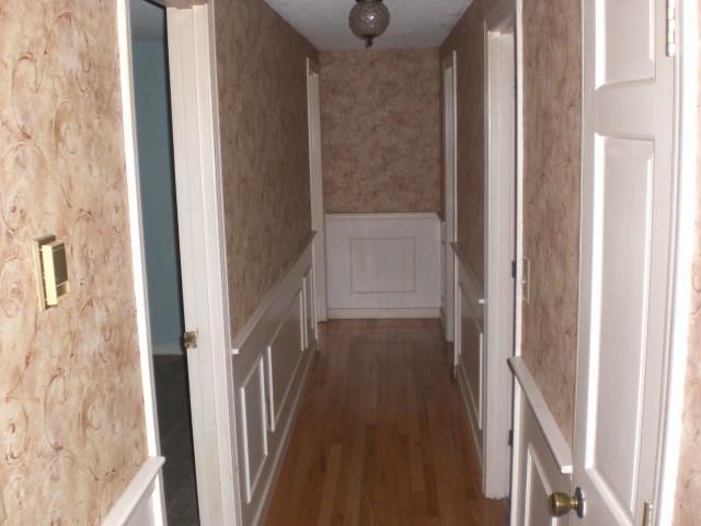 68 Westminster Road Centerville, MA 02632 - Photo 4 of 10 a view of a hallway with wooden floor and staircase