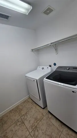 an empty room with wooden floor a ceiling fan and windows