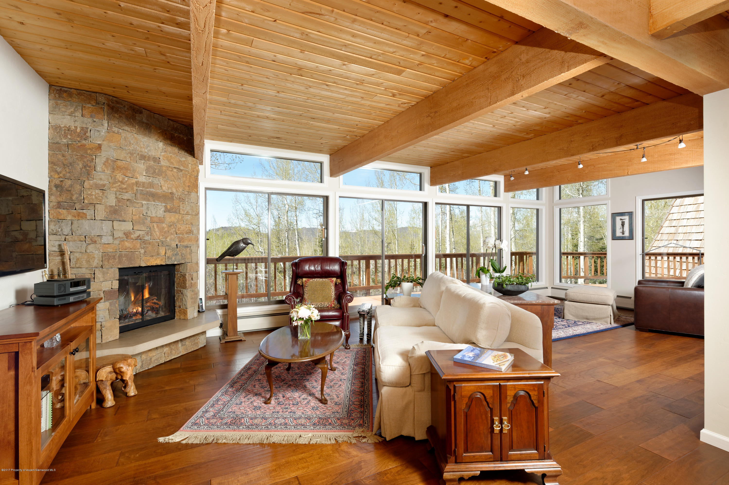 a living room with fireplace furniture and a large window