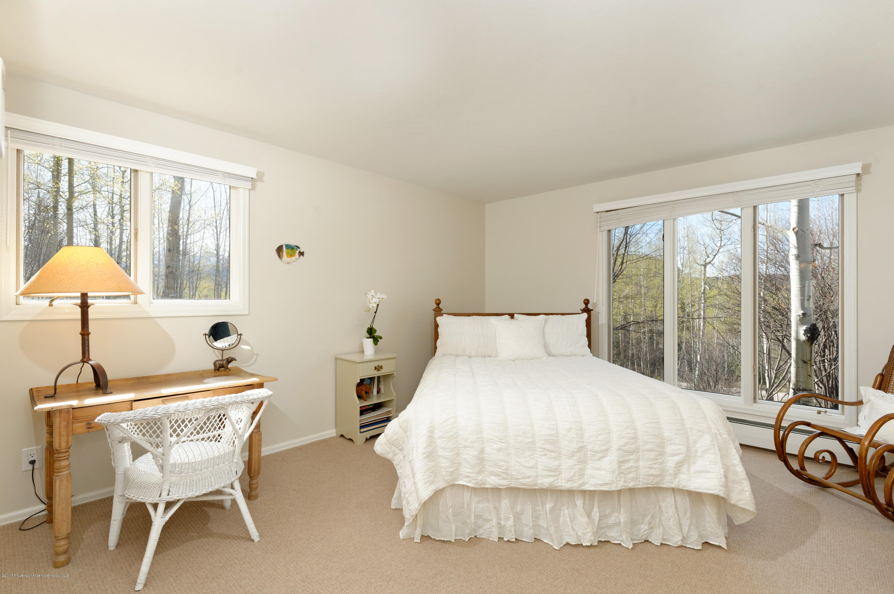 49 Elk Ridge Lane Snowmass Village, CO 81615 - Photo 12 of 24 a bedroom with a bed and a table with lamp