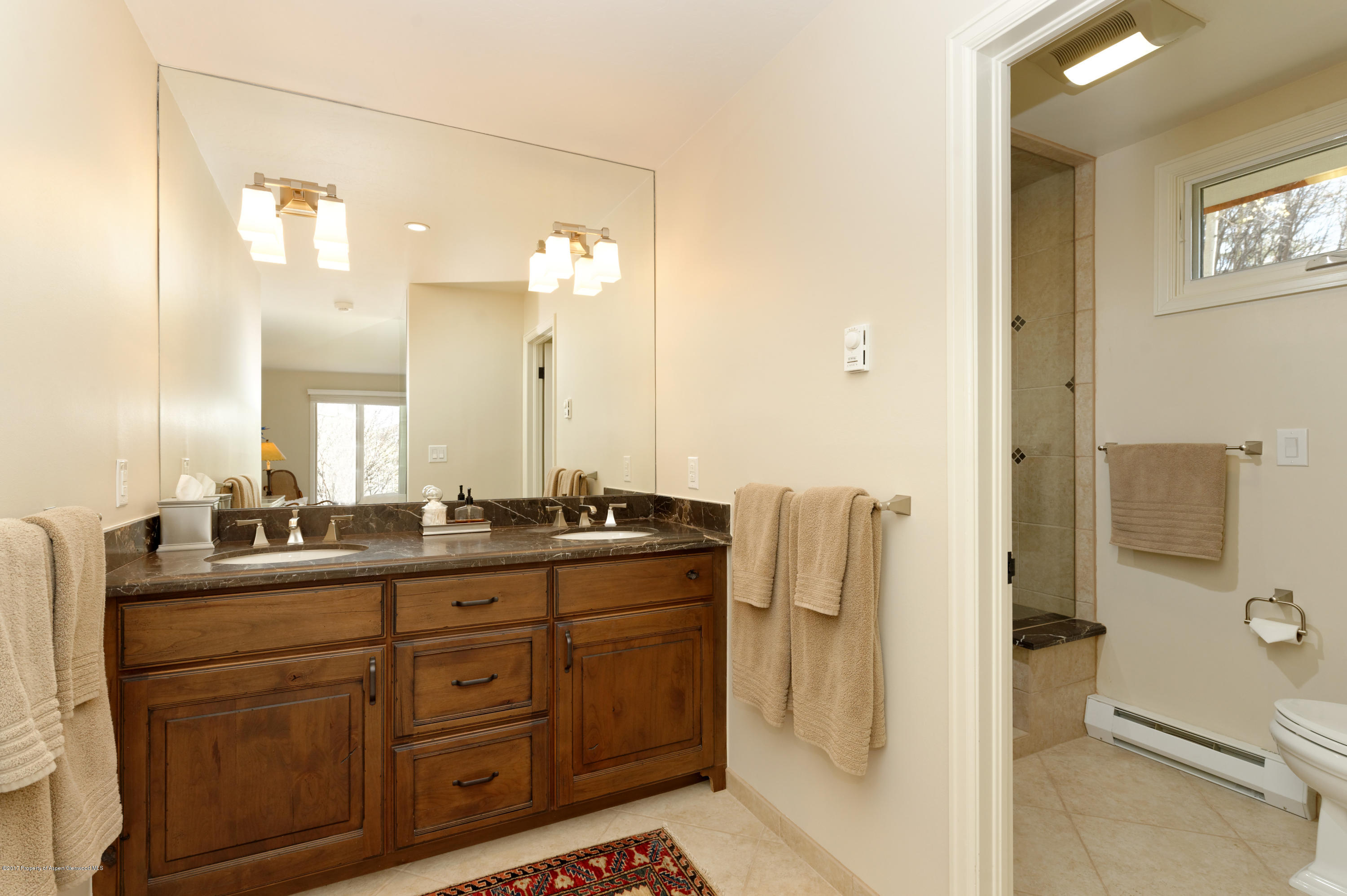 49 Elk Ridge Lane Snowmass Village, CO 81615 - Photo 13 of 24 a bathroom with a granite countertop sink mirror and a toilet