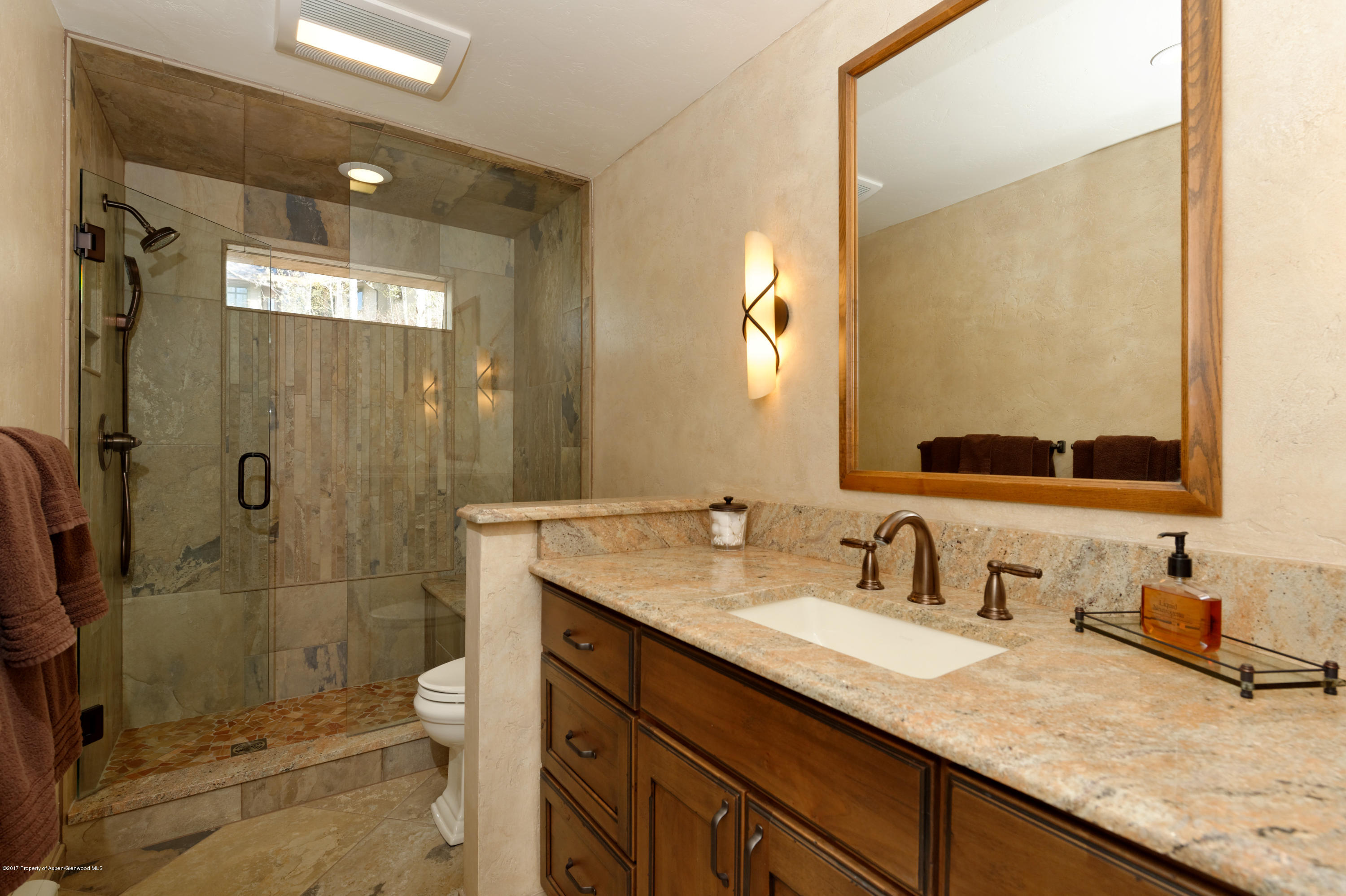 49 Elk Ridge Lane Snowmass Village, CO 81615 - Photo 15 of 24 a bathroom with a granite countertop sink mirror and shower