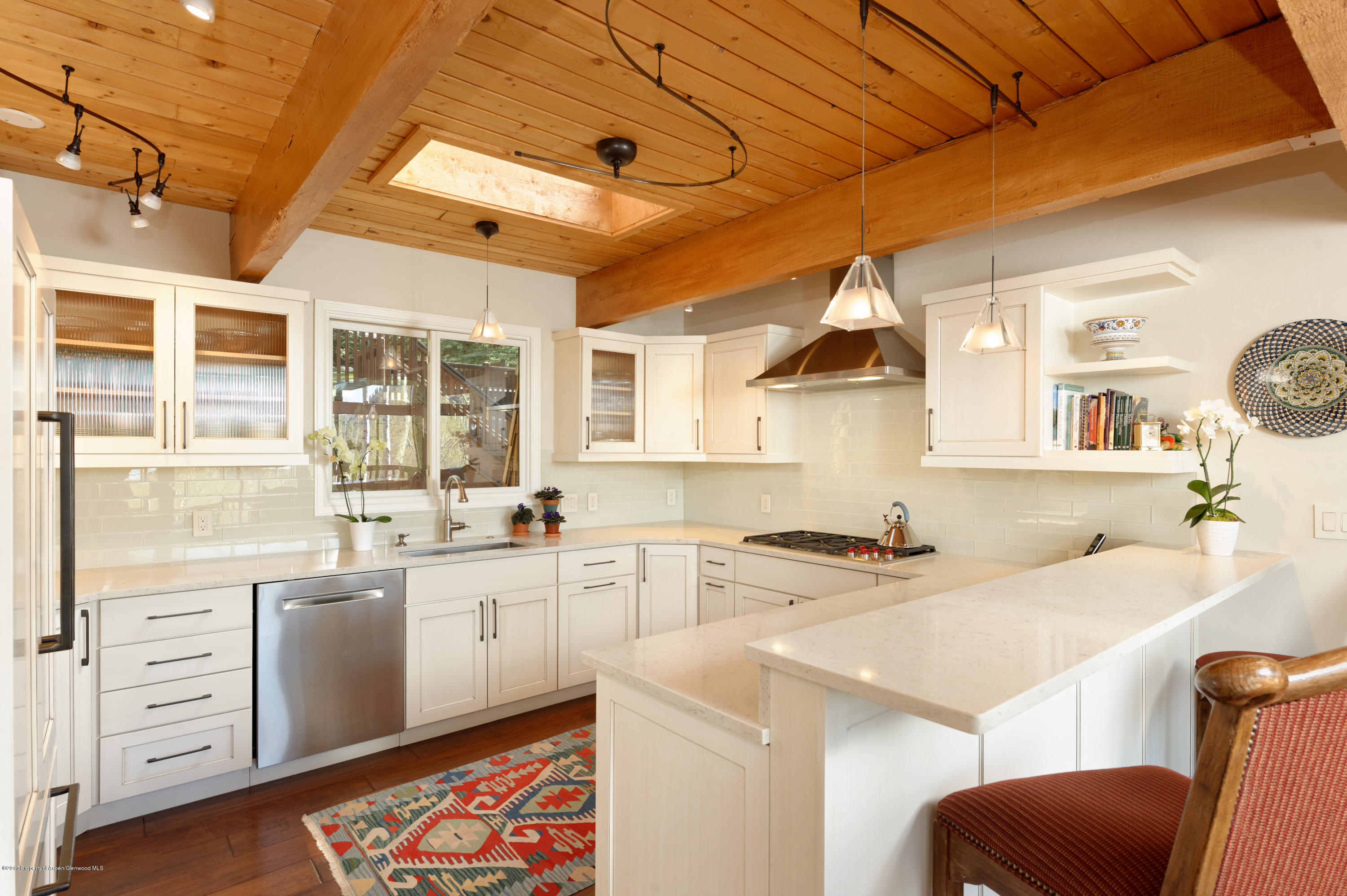 49 Elk Ridge Lane Snowmass Village, CO 81615 - Photo 7 of 24 a kitchen with a sink stove and cabinets