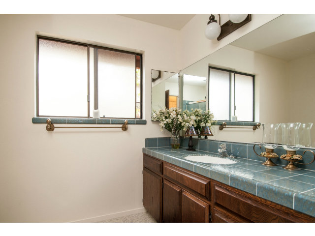 4017 Costado Road Pebble Beach, CA 93953 - Photo 18 of 25 a bathroom with a granite countertop sink a mirror and a window