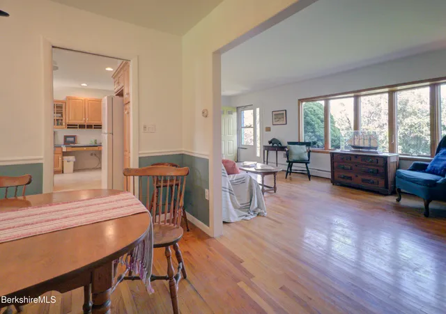 a view of a dining room with furniture window and wooden floor