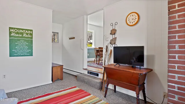 a view of a livingroom with workspace and a couch