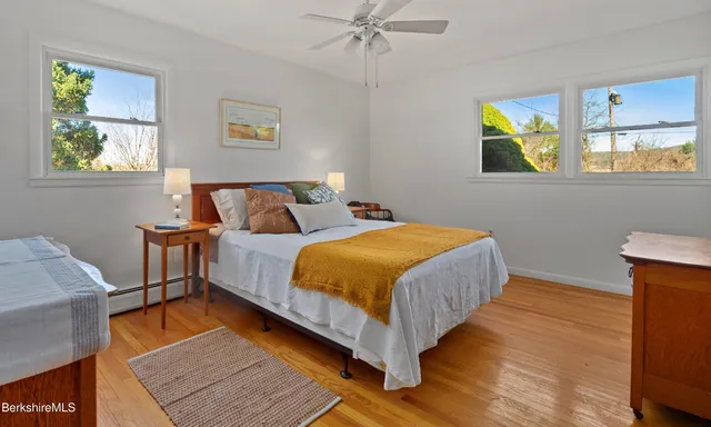 a bedroom with a bed and painting on the wall