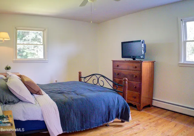 a bedroom with a bed and flat screen tv