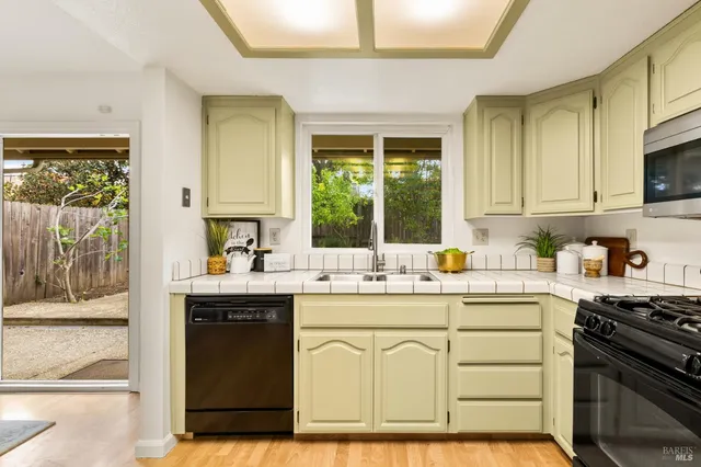 a kitchen with sink stove and cabinets