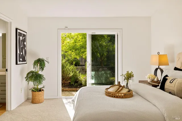 a bedroom with a bed and a potted plant