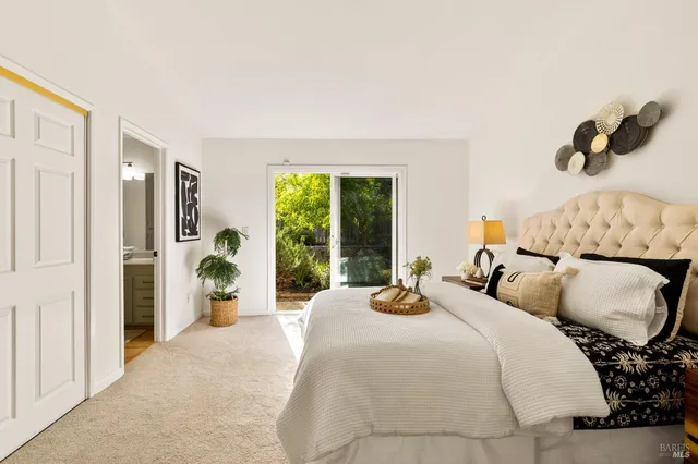 a bedroom with bed and a large window