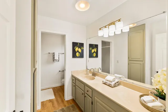a bathroom with a sink vanity granite and a mirror