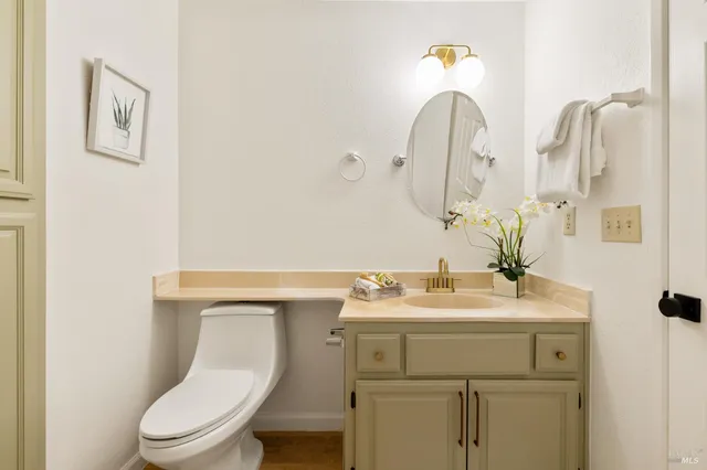 a bathroom with a toilet sink and mirror