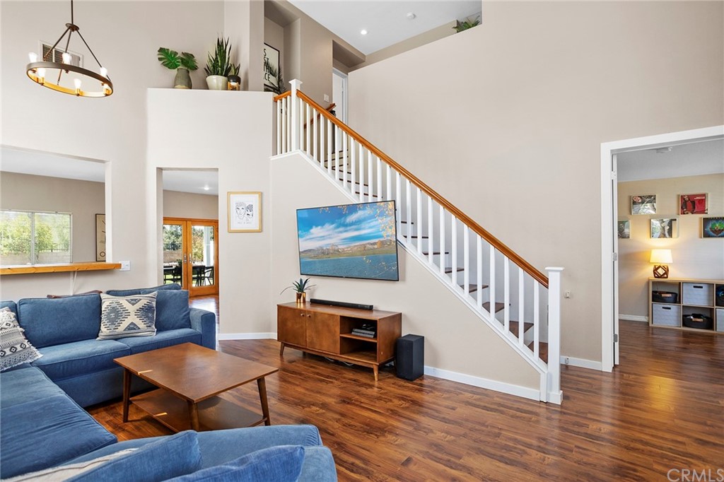 32289 Cercle Beauregard Temecula, CA 92591 - Photo 11 of 45 a living room with couches and a dining table with wooden floor