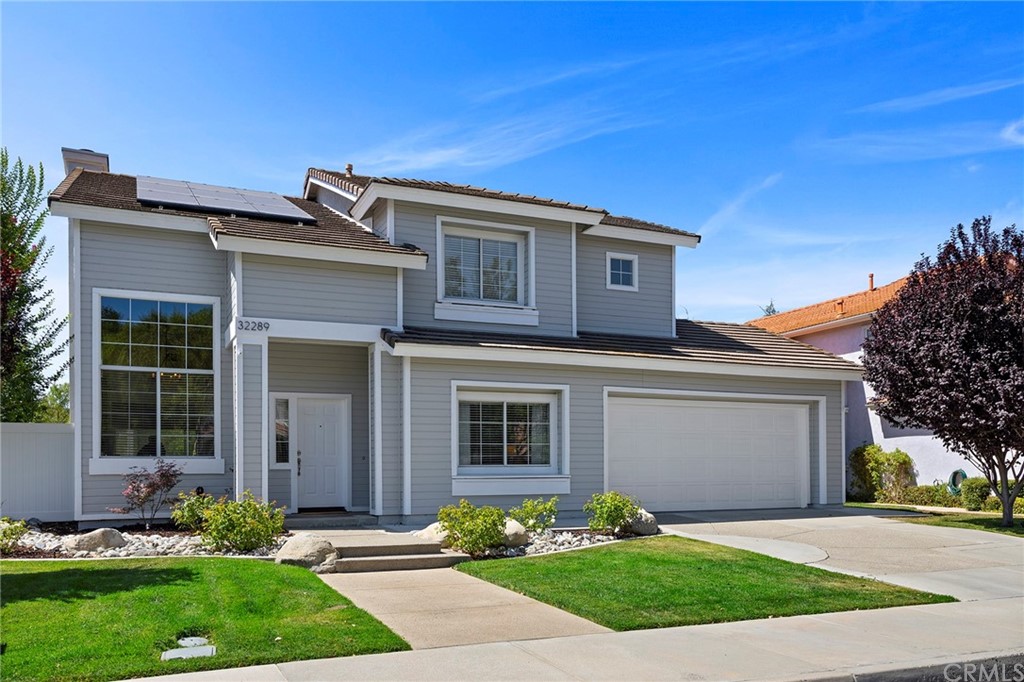 32289 Cercle Beauregard Temecula, CA 92591 - Photo 34 of 45 a front view of a house with a garden and plants