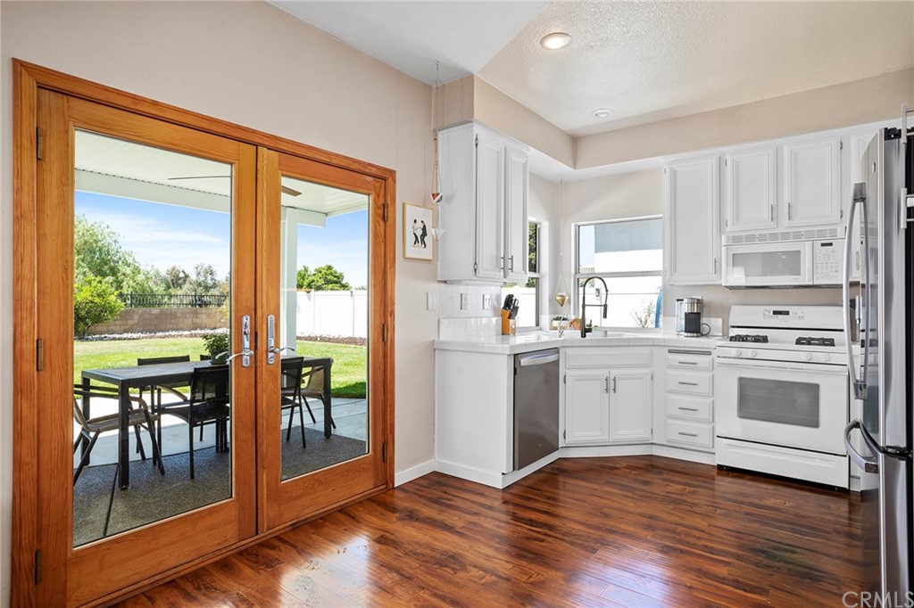 32289 Cercle Beauregard Temecula, CA 92591 - Photo 4 of 45 a kitchen with white cabinets and white appliances