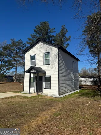 a front view of a house with a yard