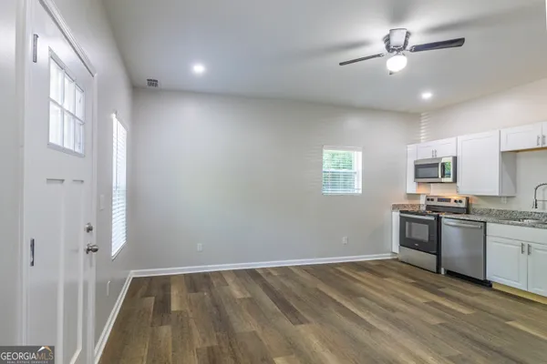a kitchen with stainless steel appliances granite countertop a stove and a refrigerator