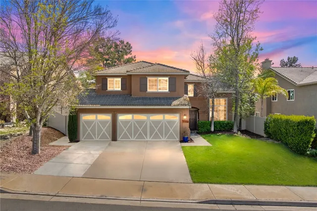 a view of a brick house with a yard