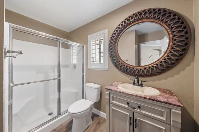 a bathroom with a toilet a sink and a mirror