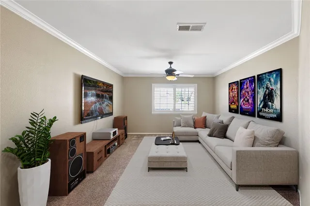 a living room with furniture a bookshelf and a painting